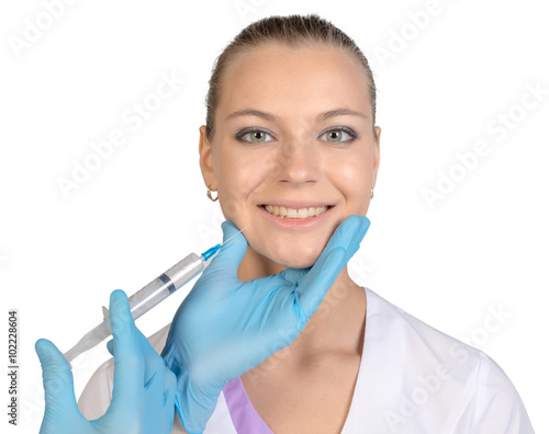 Young beautiful girl getting Botox injection from a syringe