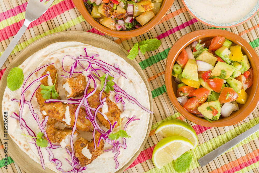 Baja Fish Tacos - Soft shell tacos filled with seasoned fried white fish served with red cabbage, pineapple salsa, chunky guacamole and creamy Baja style sauce.
Baja Fish Tacos - Soft shell tacos filled with seasoned fried white fish served with red cabbage, pineapple salsa, chunky guacamole and creamy Baja style sauce.