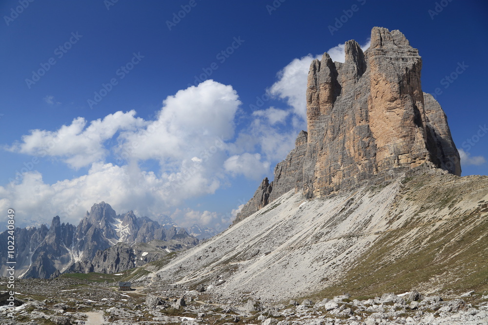 Tre Cime peaks, surrounding mountains and clouds
