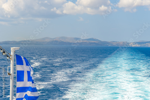 Greek flag waving over the sea.