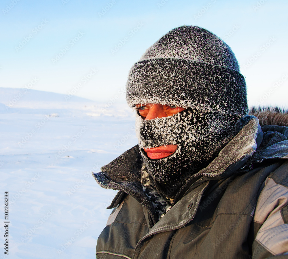 Portrait of a man in a cap and a ski mask.