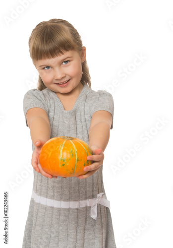 Cute little blond girl with short bangs on her head, holding in his outstretched hands a pumpkin. The plan - Isolated on white background