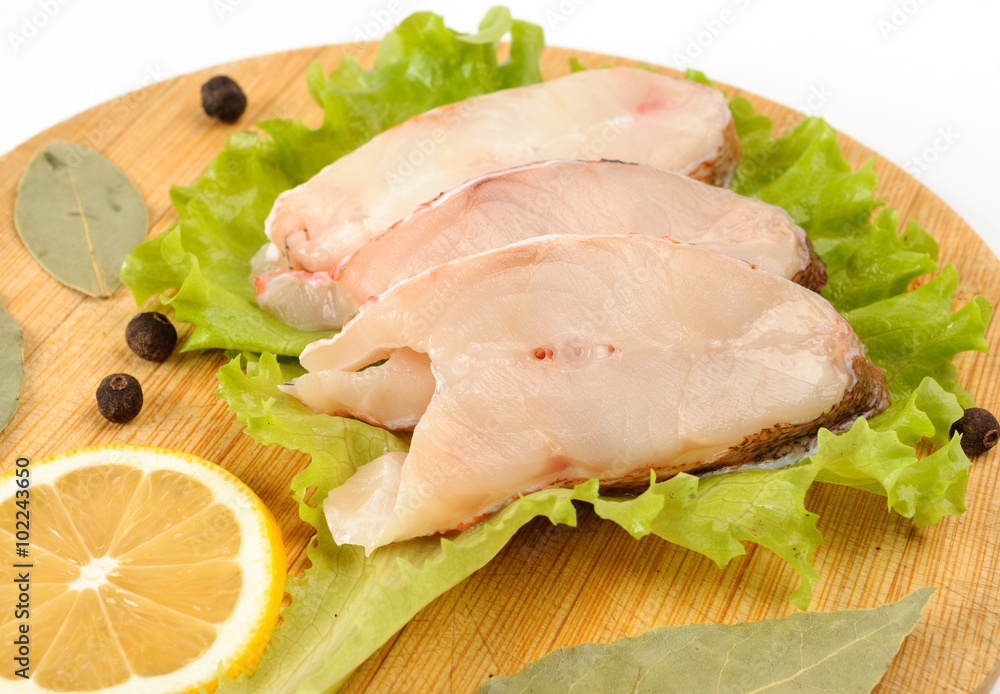 Pieces of sea bass on a cutting board. Pieces of sea bass on a cutting board.