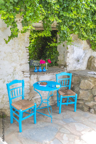 Traditional greek tavern in the narrow streets of Mykonos, Greec