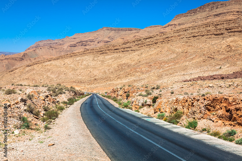 Endless road in Sahara Desert with blue sky,Morocco Africa Endless road in Sahara Desert with blue sky,Morocco Africa