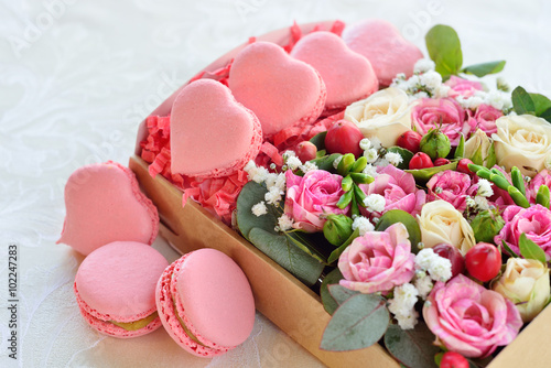 Fototapeta Naklejka Na Ścianę i Meble -  French macaroon heart-shaped Valentine's Day, the box with flowe