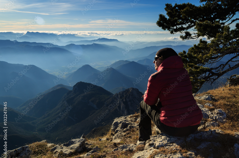 Female hiker enjoying the view from the Vercors plateau, France.
