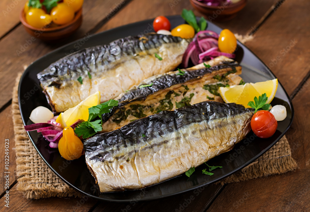 Baked mackerel with herbs and garnished with lemon and pickled vegetables Baked mackerel with herbs and garnished with lemon and pickled vegetables