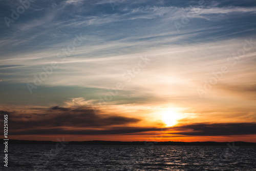 Fototapeta Naklejka Na Ścianę i Meble -  Calm sunset and clouds over lake