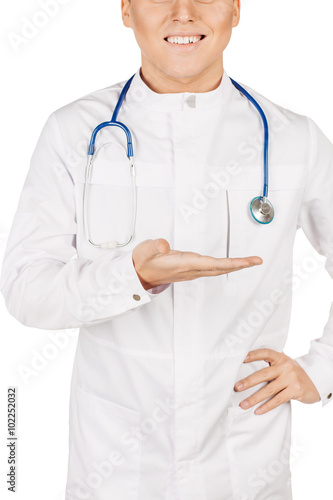 Medical doctor in white coat with stethoscope holding something