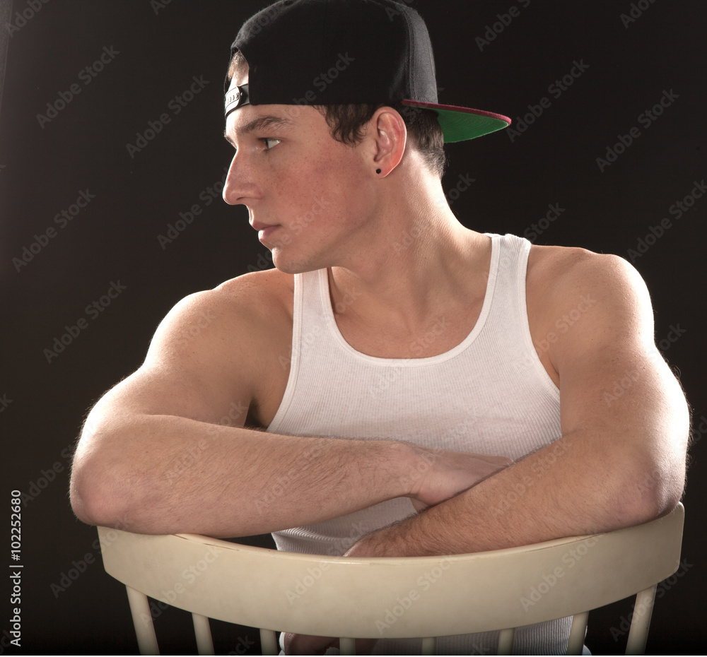 their tower beef Young Man in Chair With Backwards Baseball Cap Stock Photo | Adobe Stock