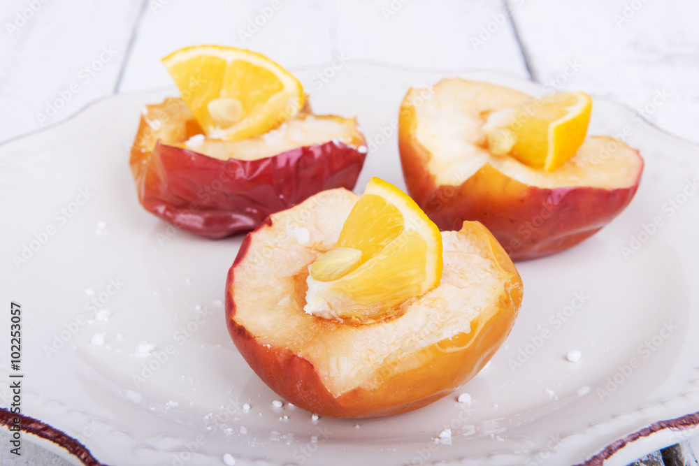 Baked apples on a plate with lemon and citrus puree of apples and pumpkins Baked apples on a plate with lemon and citrus puree of apples and pumpkins