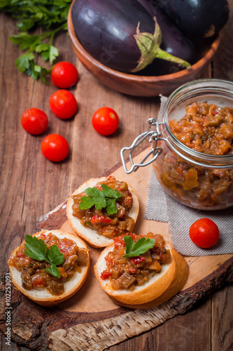 Eggplant caviar in a glass jar with croutons