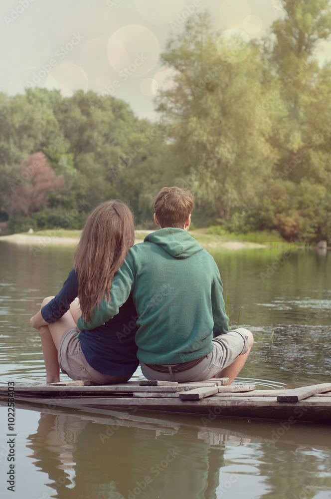 Loving couple holding hands on the river bank Loving couple holding hands on the river bank