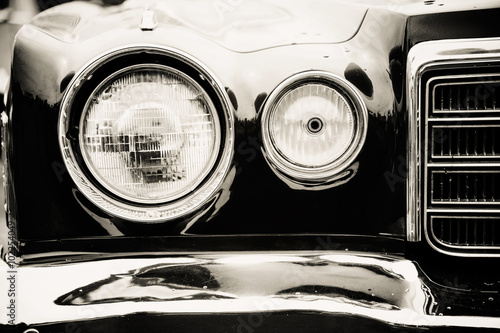 Photograph of a classic vehicle with close-up on headlights.