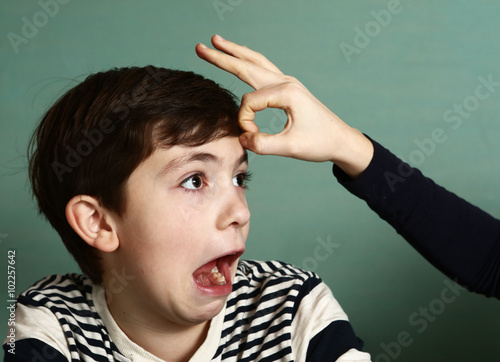 boy got fillip flick on his forehead