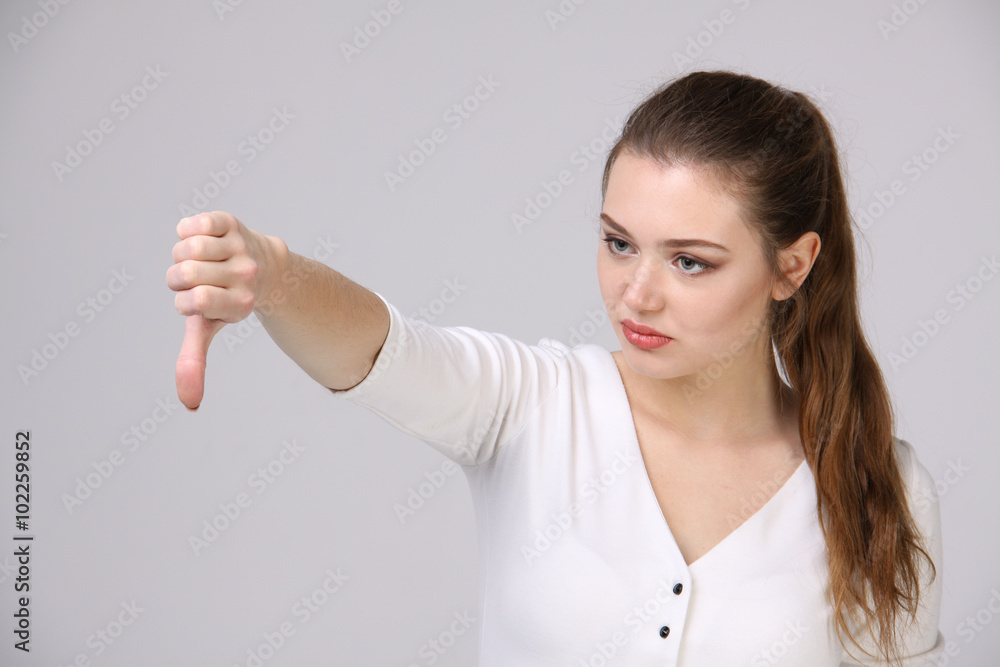 Woman showing thumb down Woman showing thumb down