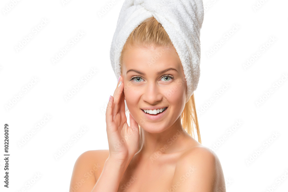 Young woman in towel smiling looking at the camera. Closeup Young woman in towel smiling looking at the camera. Closeup
