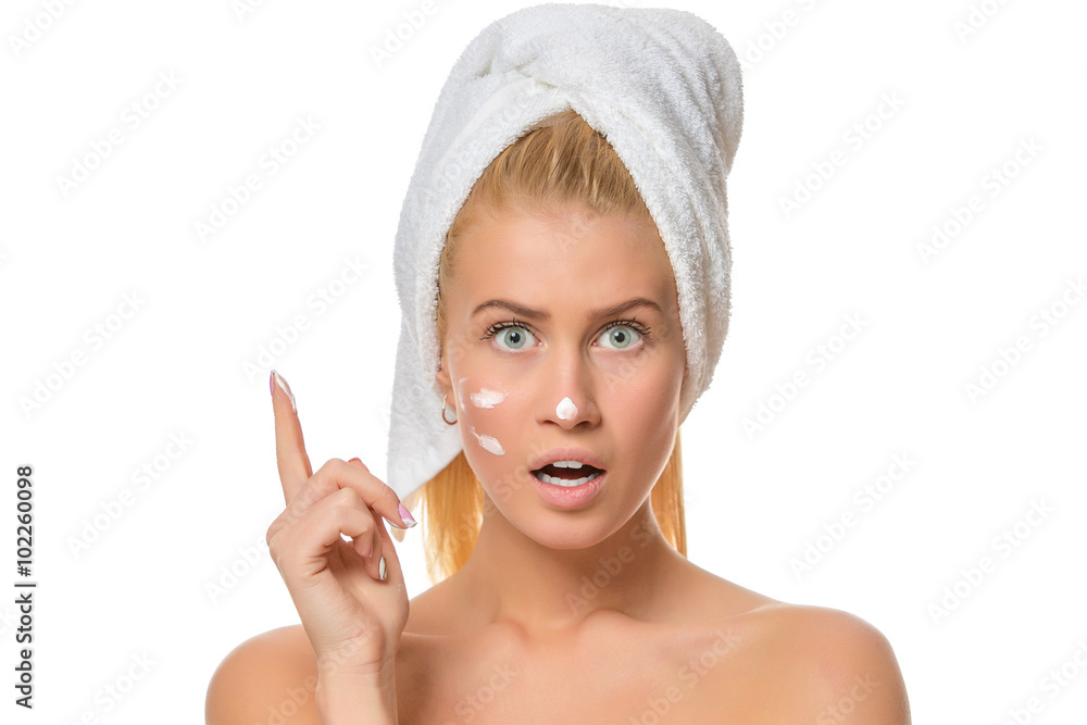 Beautiful young woman with facial cream on her nose, cheek Beautiful young woman with facial cream on her nose, cheek