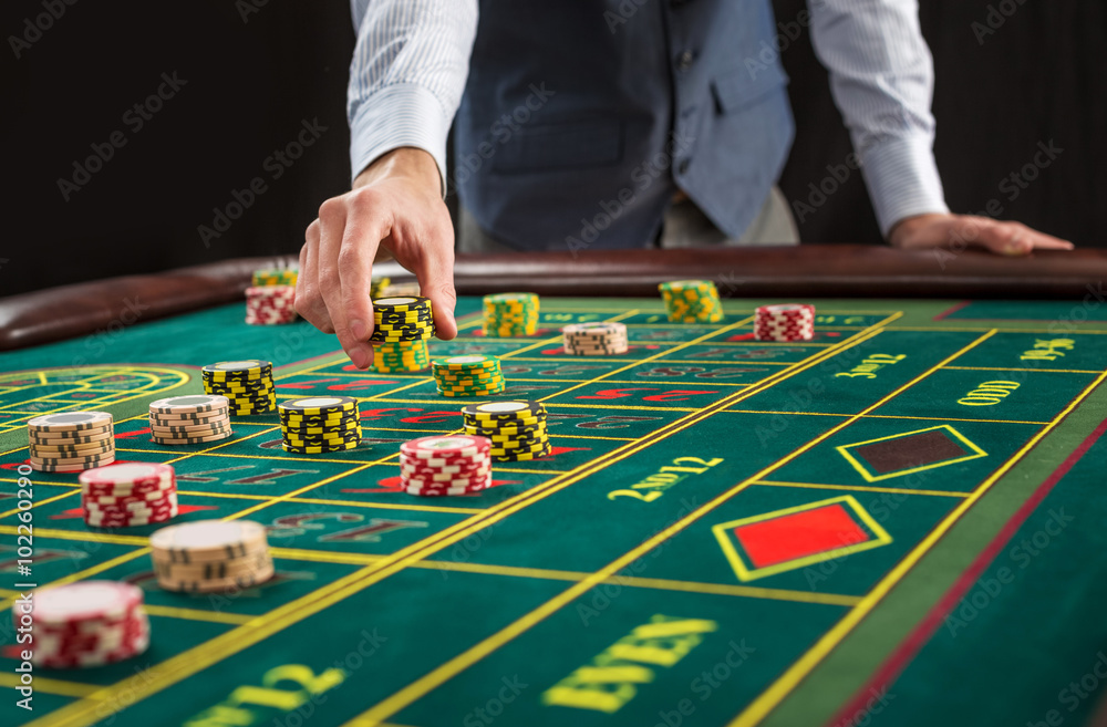 Picture of a green table and betting with chips. Picture of a green table and betting with chips.