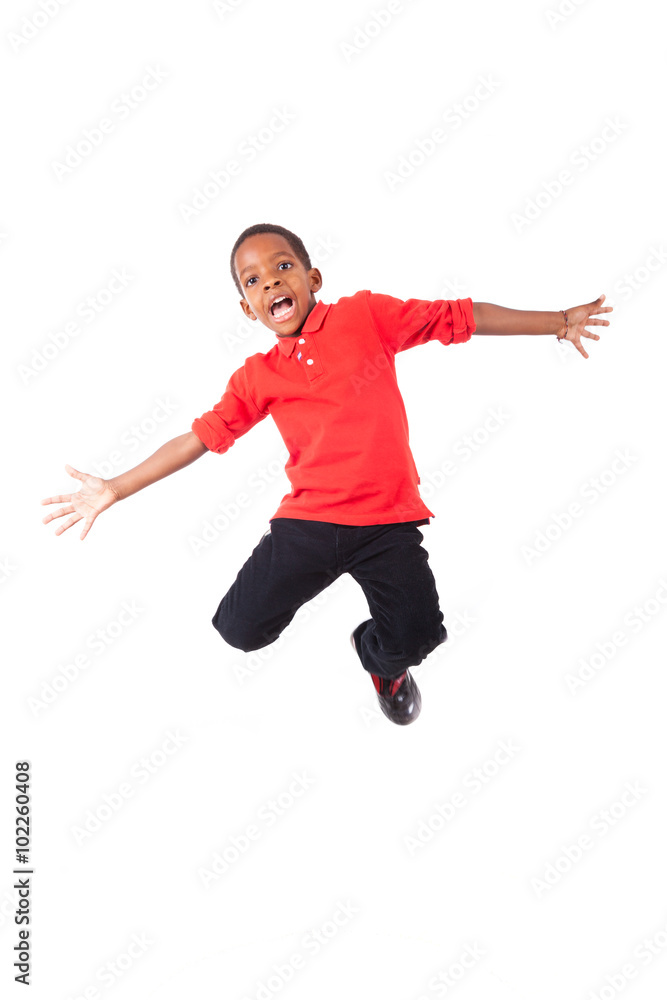 Portrait of a cute african american little boy jumping, isolated