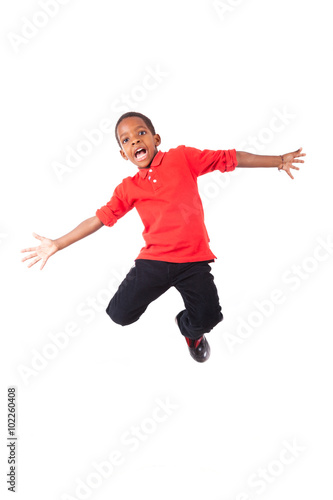 Portrait of a cute african american little boy jumping, isolated