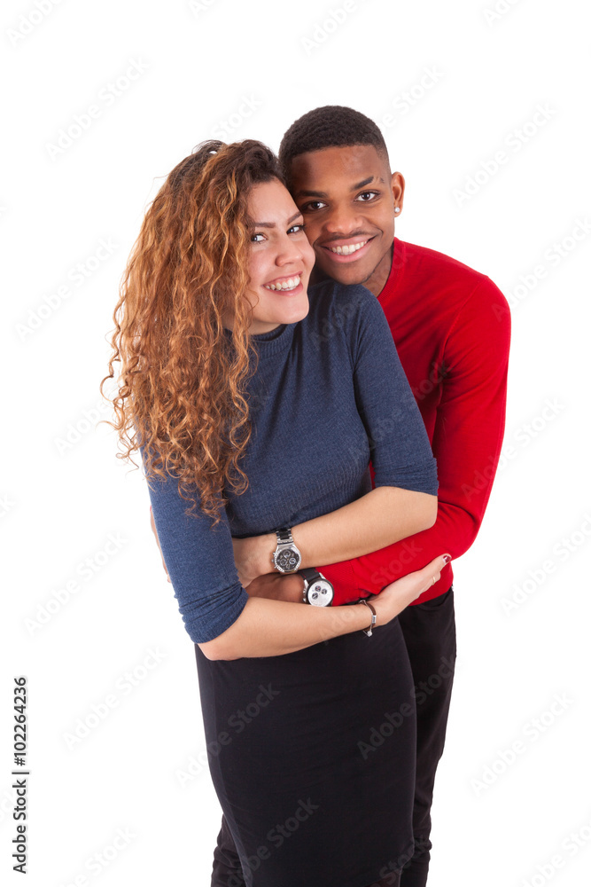 Naklejka premium Happy mixed race couple hugging over a white background