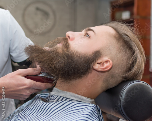 Handsome man with a long mustache in barbershop