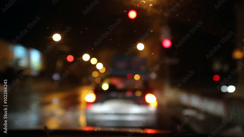 Traffic,driving on a rainy night wet road. Bad weather, rain and wet snow on the road. headlights of cars , rain drops and wet snow on the windshield. Traffic,driving on a rainy night wet road. Bad weather, rain and wet snow on the road. headlights of cars , rain drops and wet snow on the windshield.