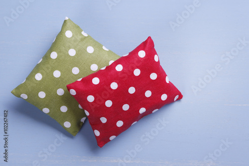Red and green spotted pillow