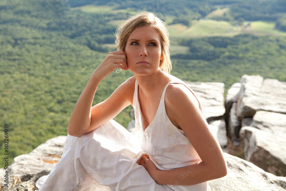 Beautiful Woman in White Dress in Mountains
