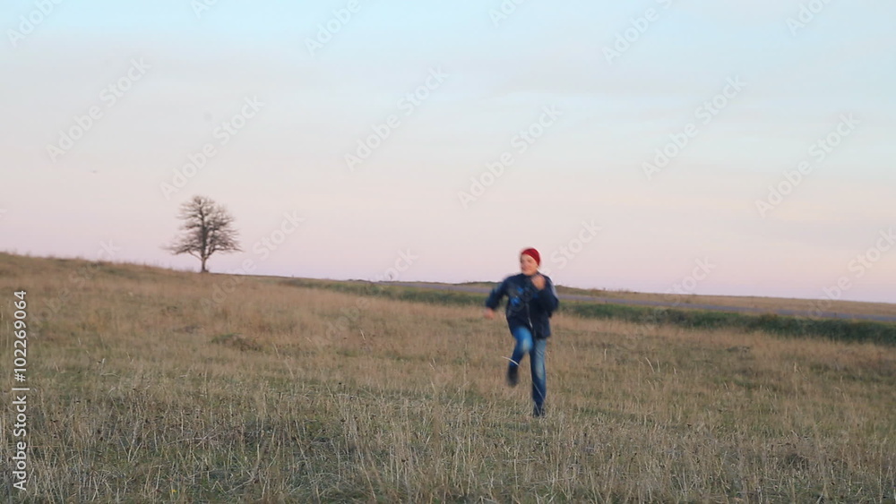 The child boy teen runs across the field. Childhood dreams and memories. The child boy teen runs across the field. Childhood dreams and memories.