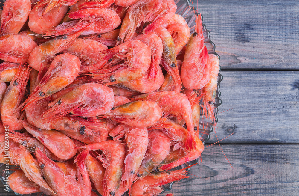Large glass dish with a large frozen shrimp Large glass dish with a large frozen shrimp