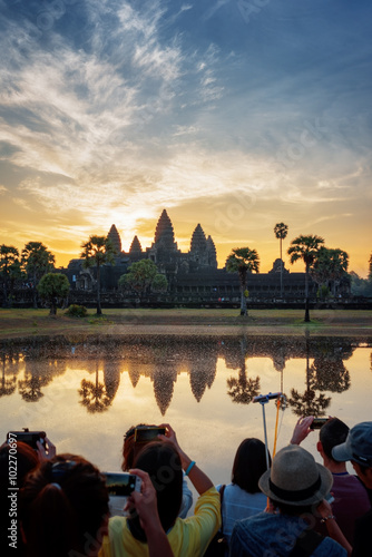 Tourists taking picture of Angkor Wat at sunrise, Cambodia