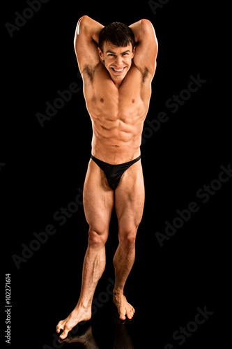 Bodybuilder Posing on Black