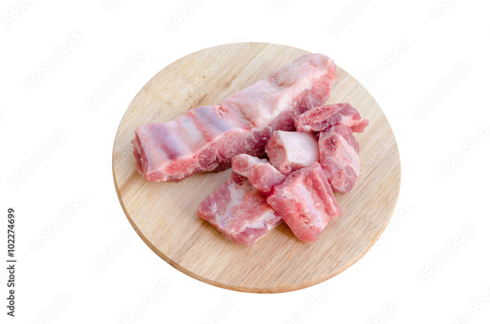 Raw ribs on wooden cutting board isolated on white Raw ribs on wooden cutting board isolated on white