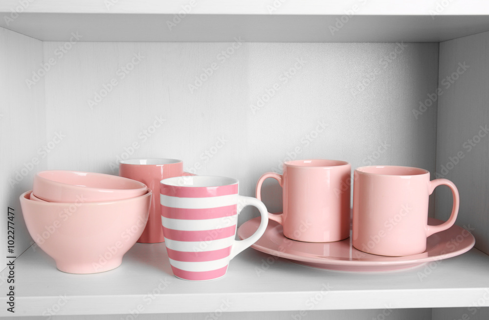 Tableware on shelf in the kitchen cupboard Tableware on shelf in the kitchen cupboard