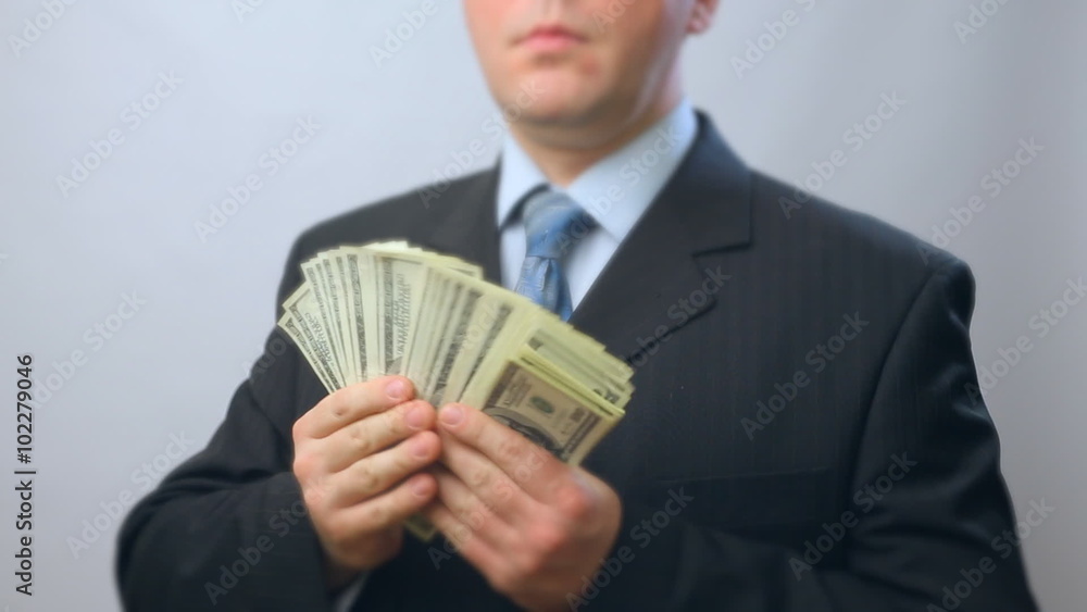 Male person counting money, lots of hundred U.S. dollar banknotes. Businessman with lots of one hundred US dollars banknotes. Ready money, ready cash buy, sell, loan Male person counting money, lots of hundred U.S. dollar banknotes. Businessman with lots of one hundred US dollars banknotes. Ready money, ready cash buy, sell, loan
