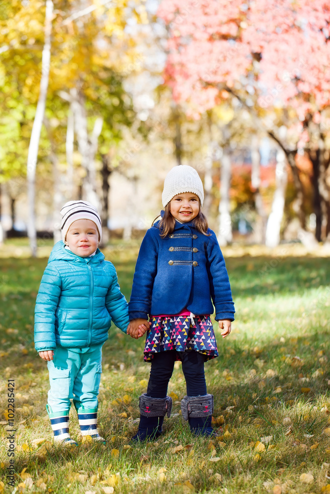 Little girls running in autumn park Little girls running in autumn park