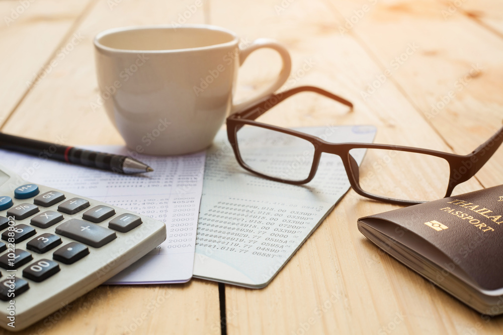 Bank account Pen,glasses ,coffee cup and calculator with passpor Bank account Pen,glasses ,coffee cup and calculator with passpor