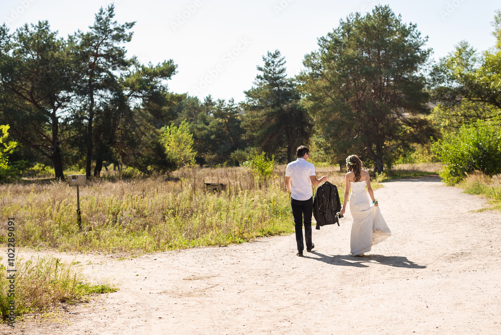 bride and groom go for a walk