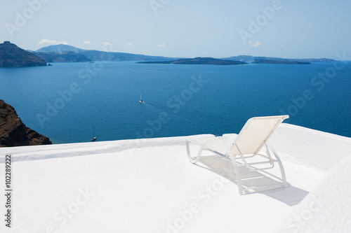 Deck chair on the terrace with sea view. © smallredgirl