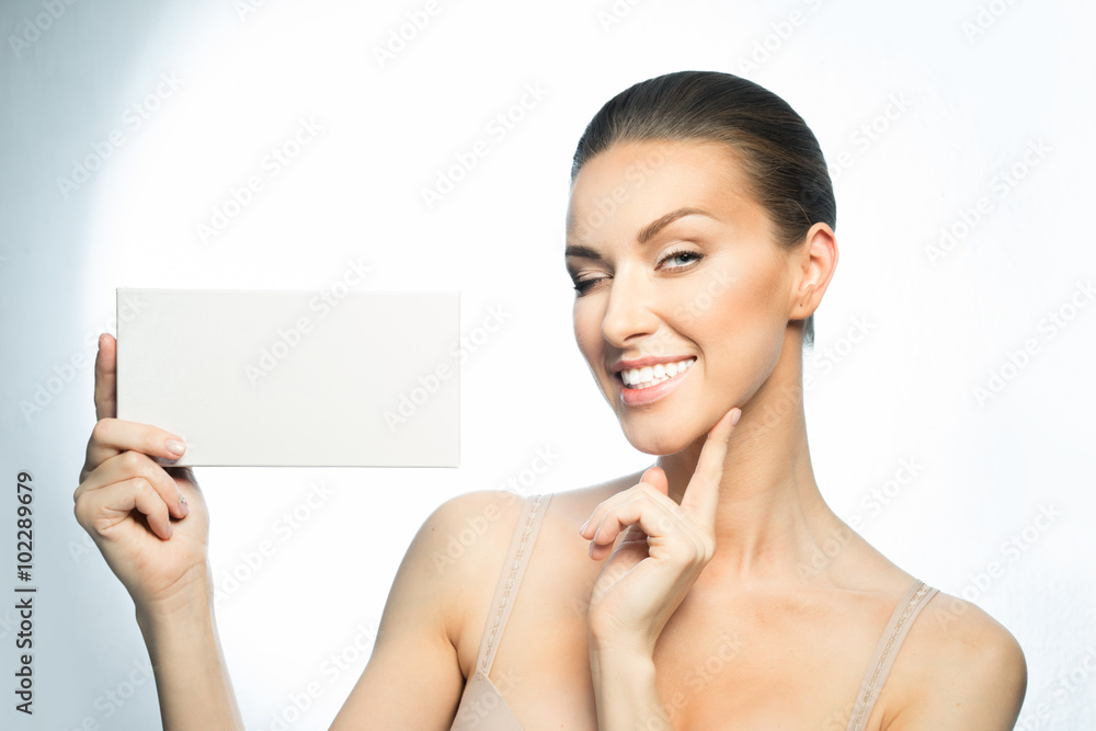 Woman smiling showing blank card for your ad. Woman smiling showing blank card for your ad.