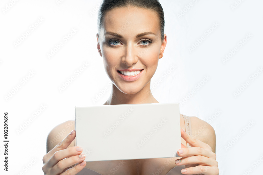 Girl with natural make-up showing a blank card for your ad and smiling Girl with natural make-up showing a blank card for your ad and smiling