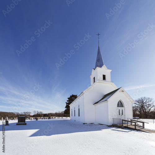 Old white country church in winter with snow