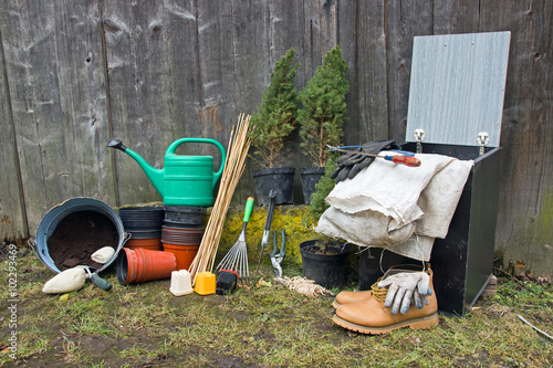 Gardening Tools with Watering Can,Flowerpots and Other Tools in Front of Garden Shed