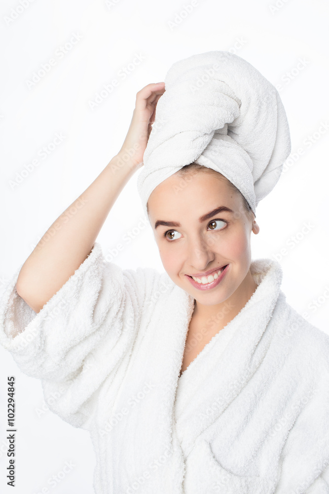 Pretty smiling young woman with white towel on her head and light makeup, studio portrait Pretty smiling young woman with white towel on her head and light makeup, studio portrait