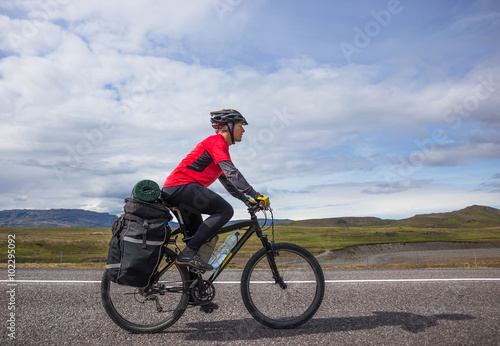 Fototapeta Naklejka Na Ścianę i Meble -  Happy biker ride on road in Iceland. Travel and sport picture