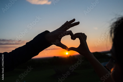 Silhouette of heart from two hands