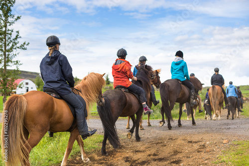 Group of horseback riders ride  in Iceland photo